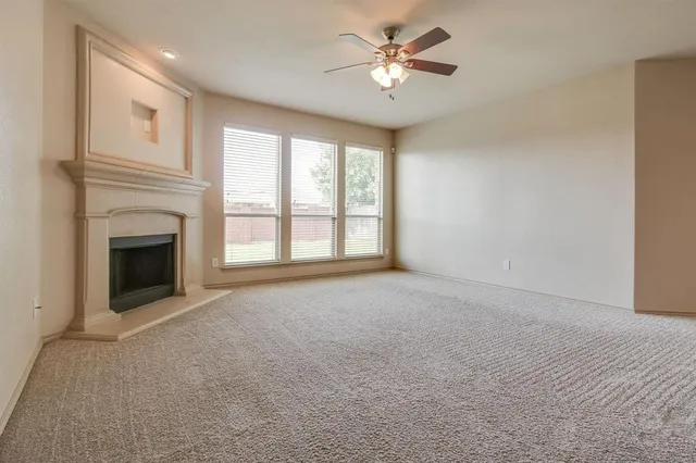 a view of empty room with a fireplace