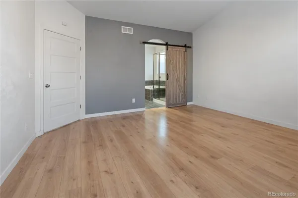 a utility room with wooden floor and cabinets