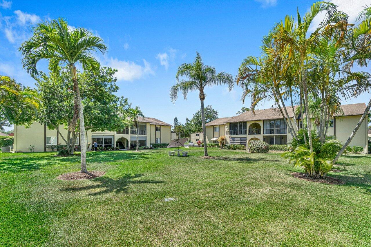 308 Pine Ridge Circle, Unit C2 Greenacres, FL 33463 - Photo 3 of 23 Grassy Area In Front Of Condo
