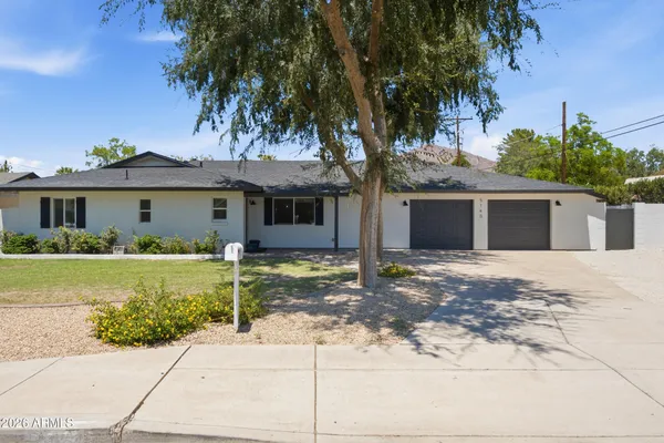 a front view of a house with a garden