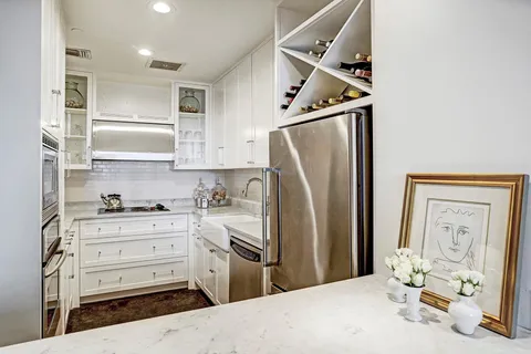a kitchen with stainless steel appliances a refrigerator and cabinets