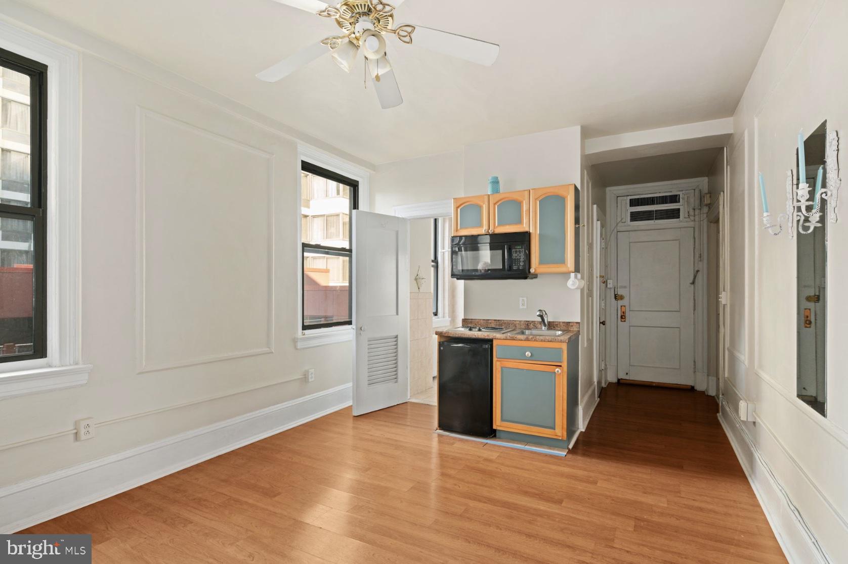 1324 Locust Street, Unit 619 Philadelphia, PA 19107 - Photo 2 of 19 a kitchen with a refrigerator and a stove top oven