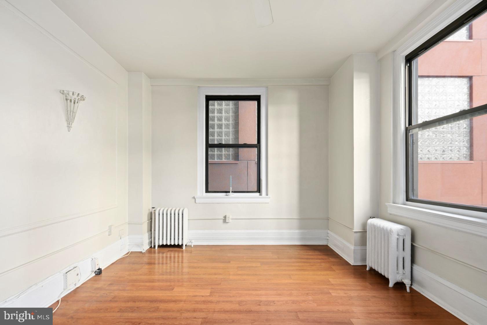 1324 Locust Street, Unit 619 Philadelphia, PA 19107 - Photo 3 of 19 a bedroom with a bed and a window