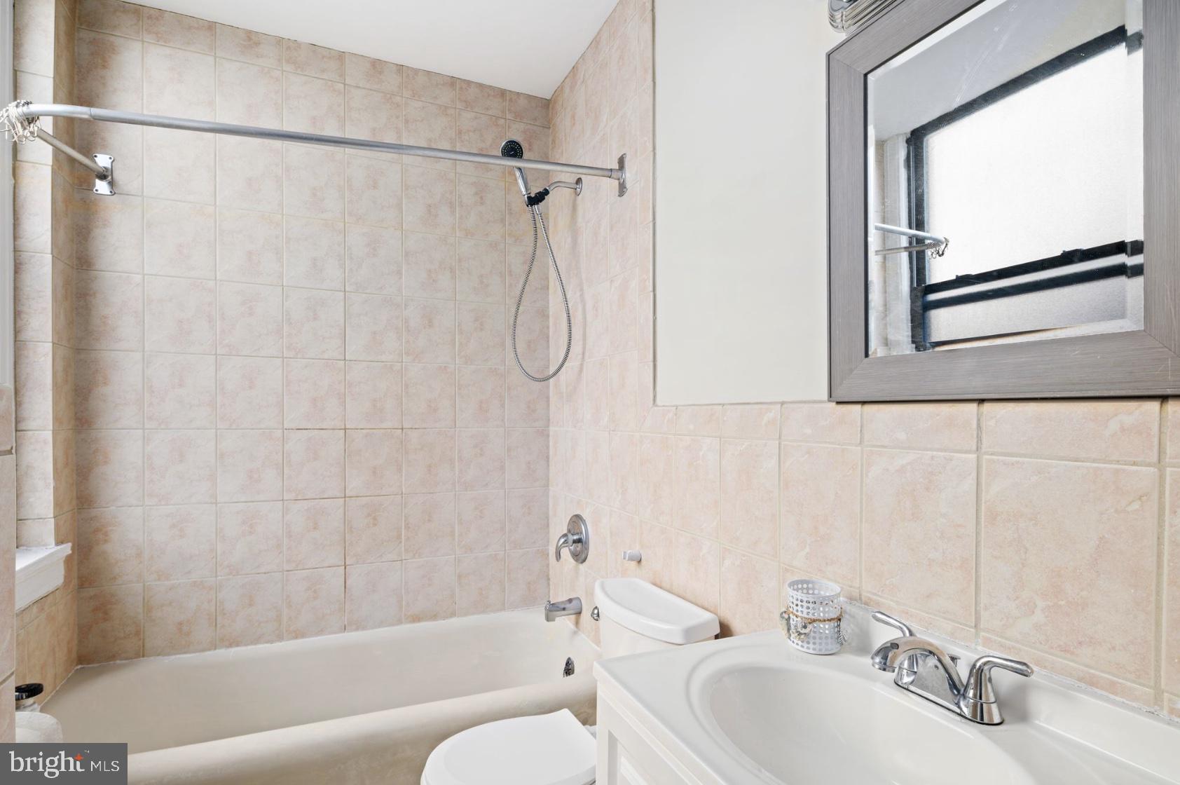 1324 Locust Street, Unit 619 Philadelphia, PA 19107 - Photo 4 of 19 a bathroom with a sink and a bathtub