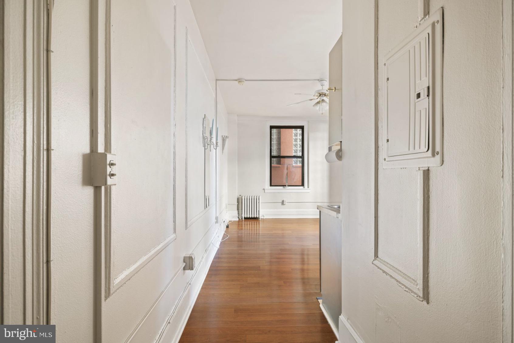 1324 Locust Street, Unit 619 Philadelphia, PA 19107 - Photo 8 of 19 a view of a hallway with wooden floor and staircase