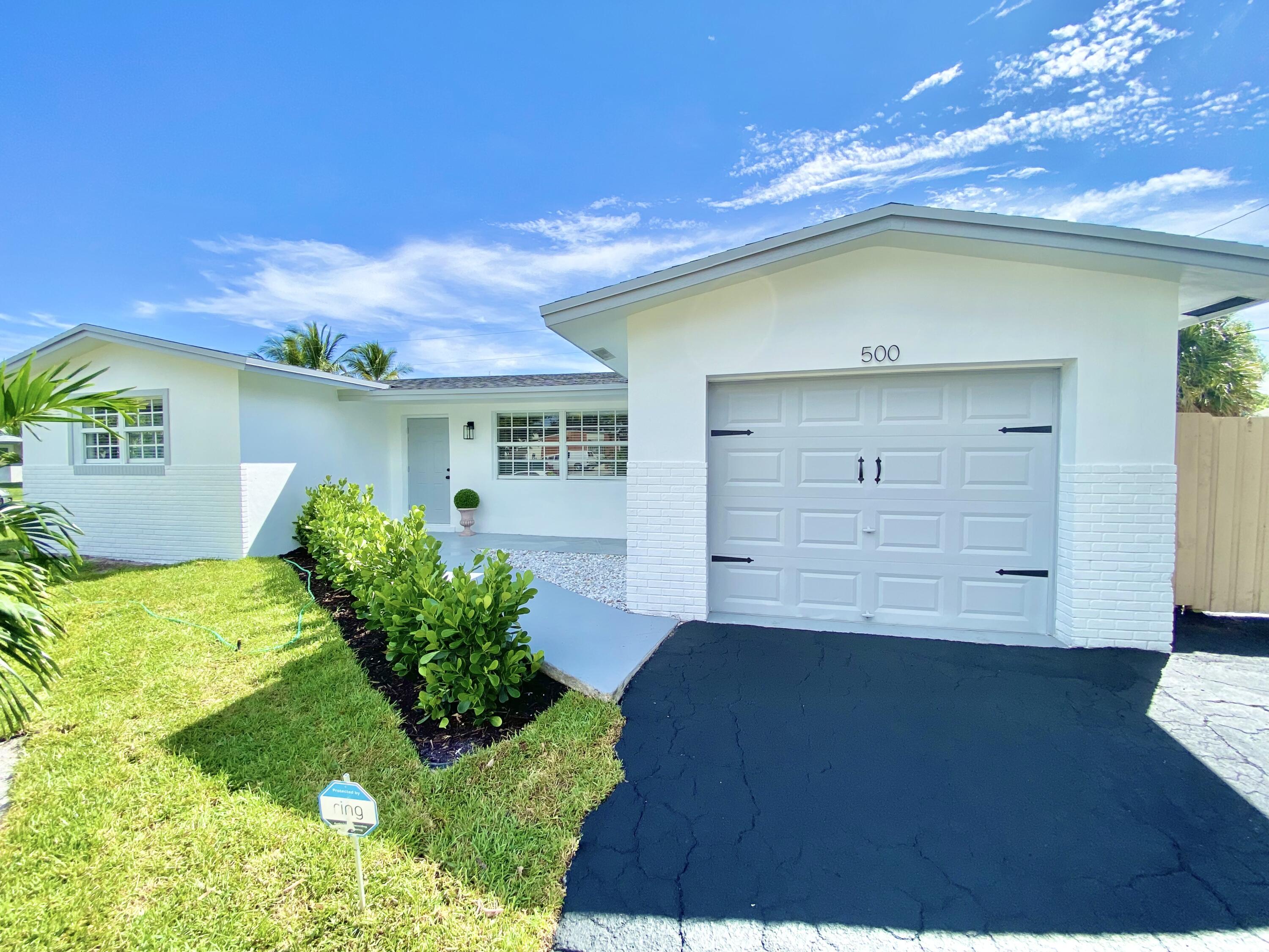 500 Southwest 3rd Avenue Boca Raton, FL 33432 - Photo 1 of 39 a front view of a house with a yard