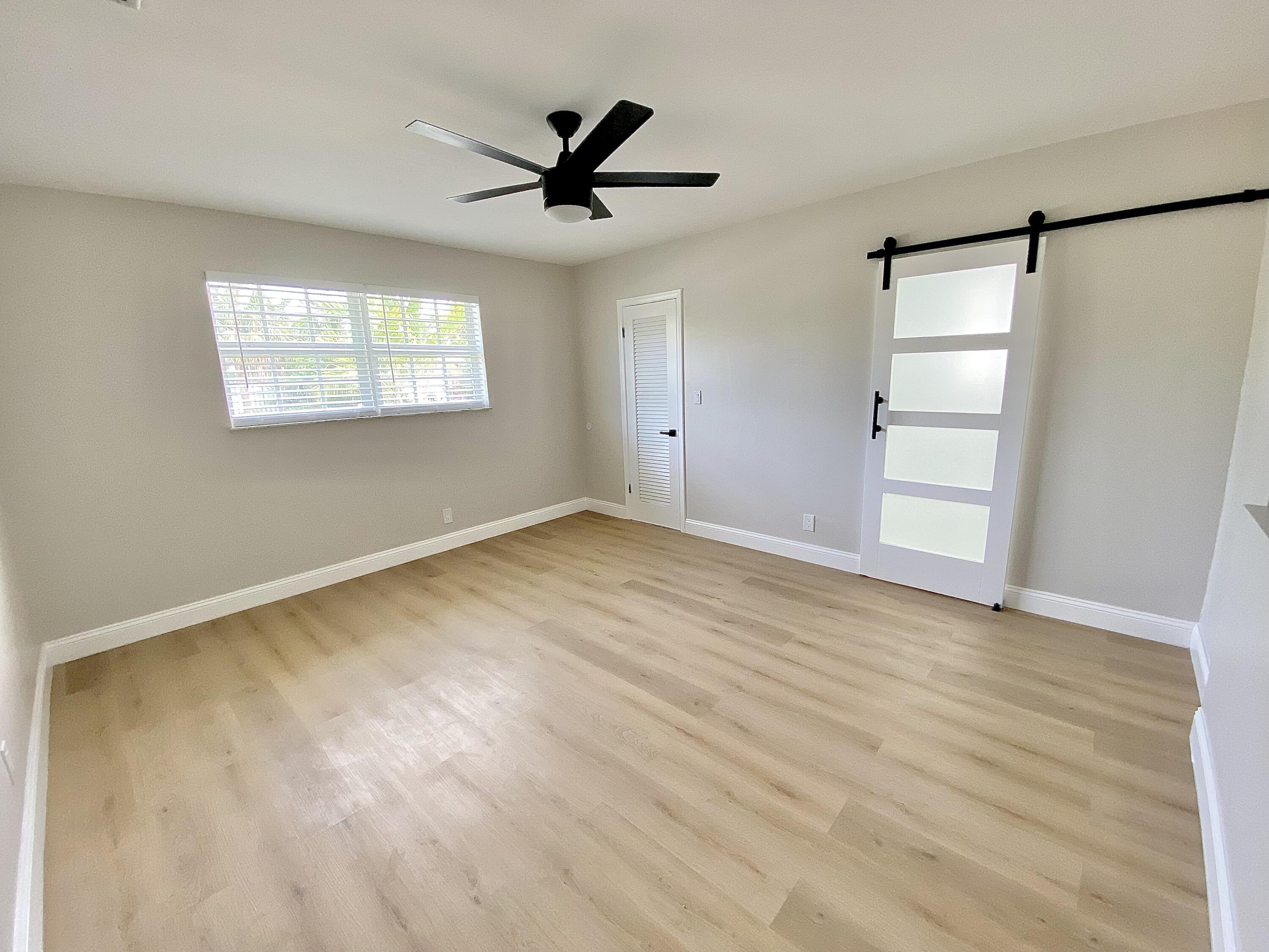 500 Southwest 3rd Avenue Boca Raton, FL 33432 - Photo 12 of 39 a view of empty room with wooden floor and fan