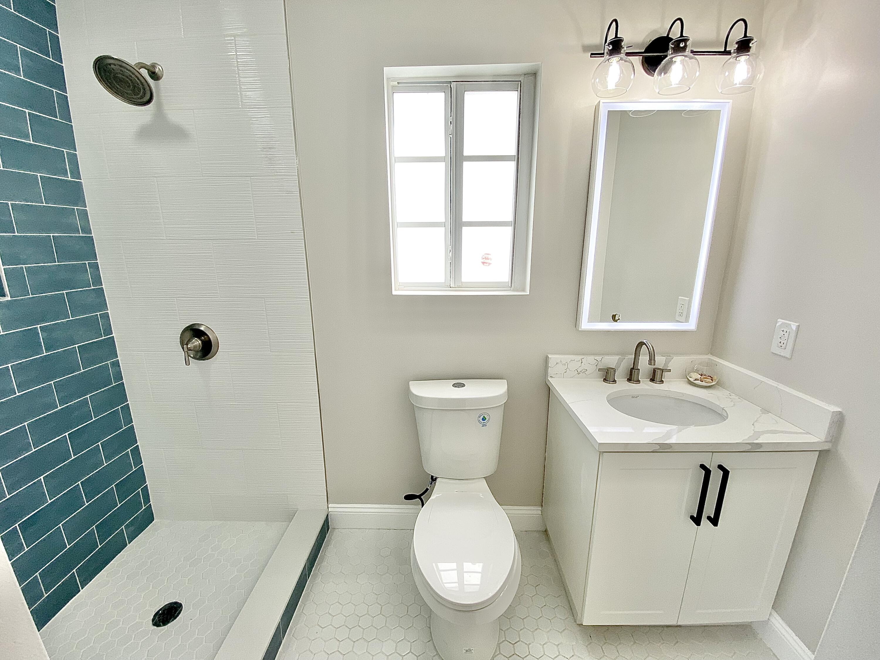 500 Southwest 3rd Avenue Boca Raton, FL 33432 - Photo 14 of 39 a bathroom with a sink a toilet and a mirror