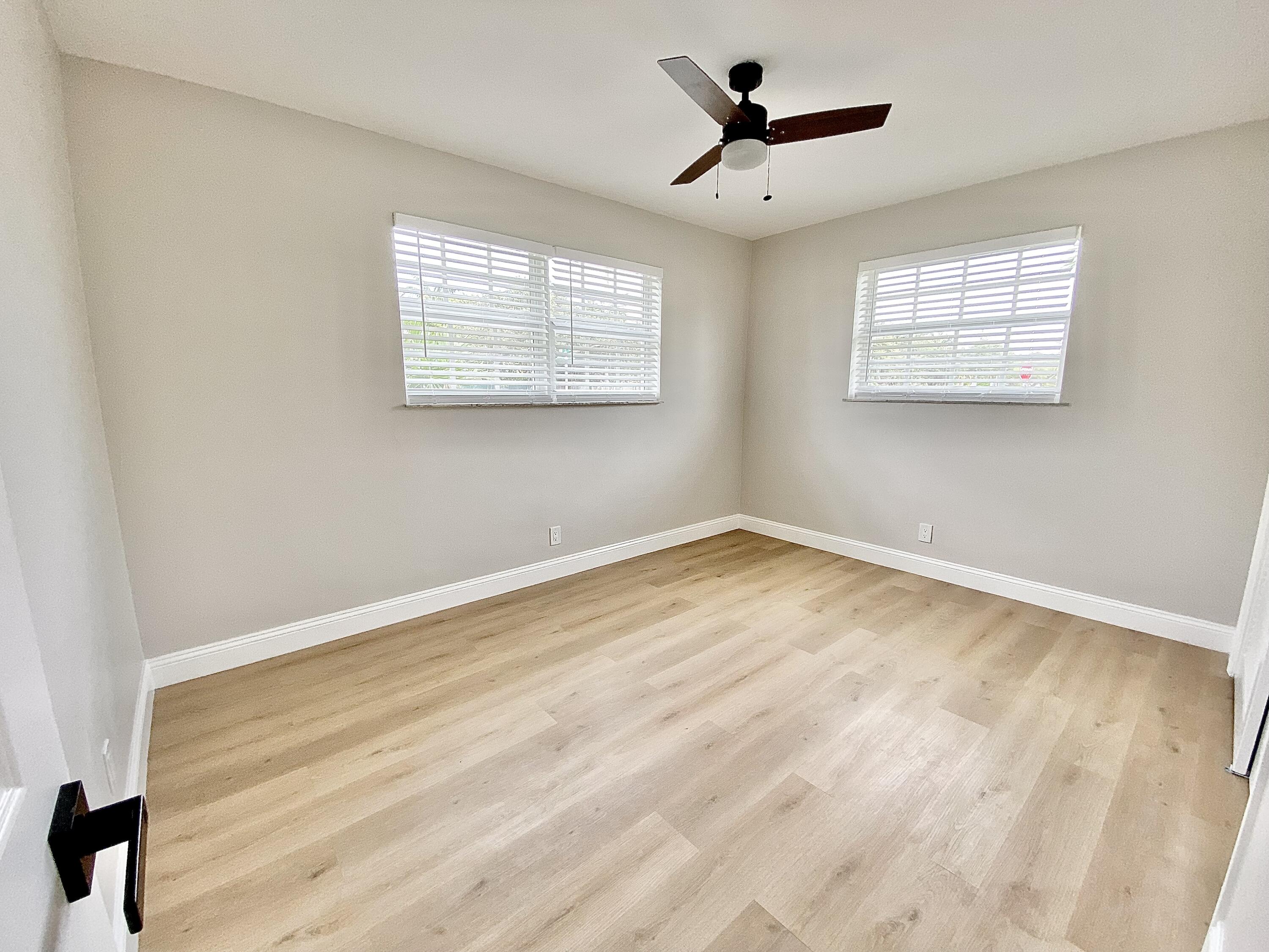 500 Southwest 3rd Avenue Boca Raton, FL 33432 - Photo 18 of 39 a view of a room with wooden floor and a ceiling fan