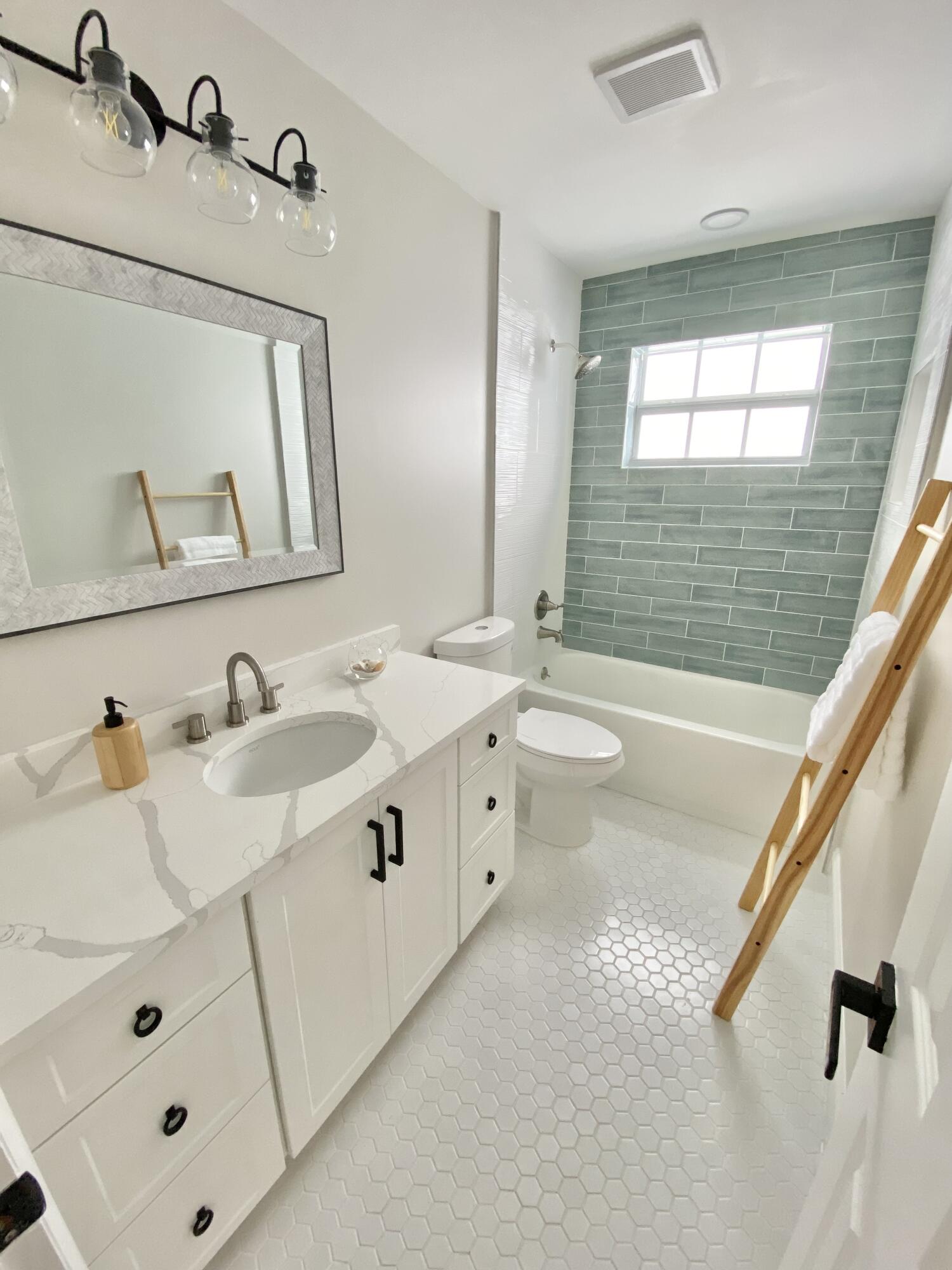 500 Southwest 3rd Avenue Boca Raton, FL 33432 - Photo 19 of 39 a spacious bathroom with a double vanity sink a mirror and a bathtub