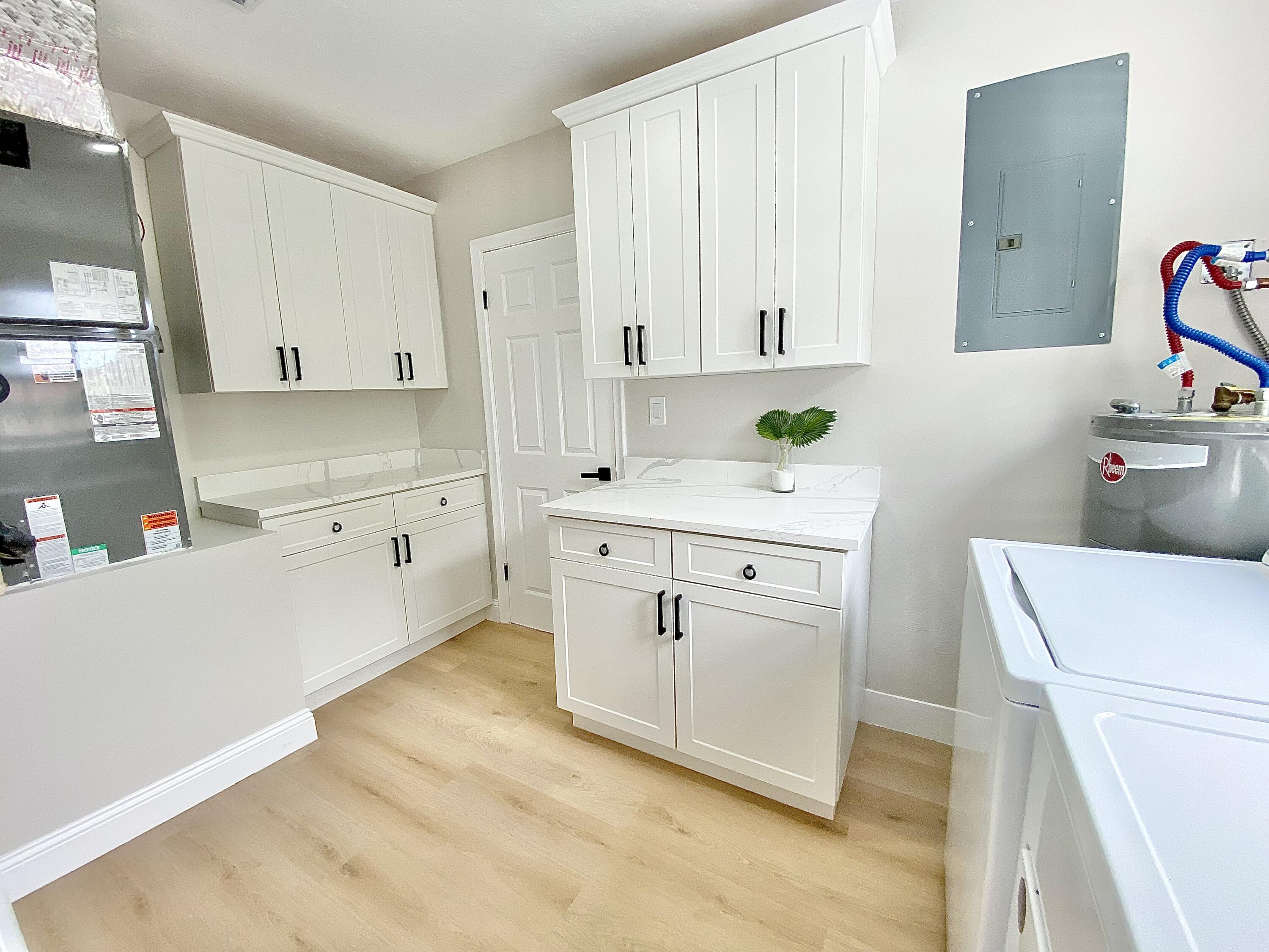 500 Southwest 3rd Avenue Boca Raton, FL 33432 - Photo 28 of 39 a utility room with cabinets washer and dryer