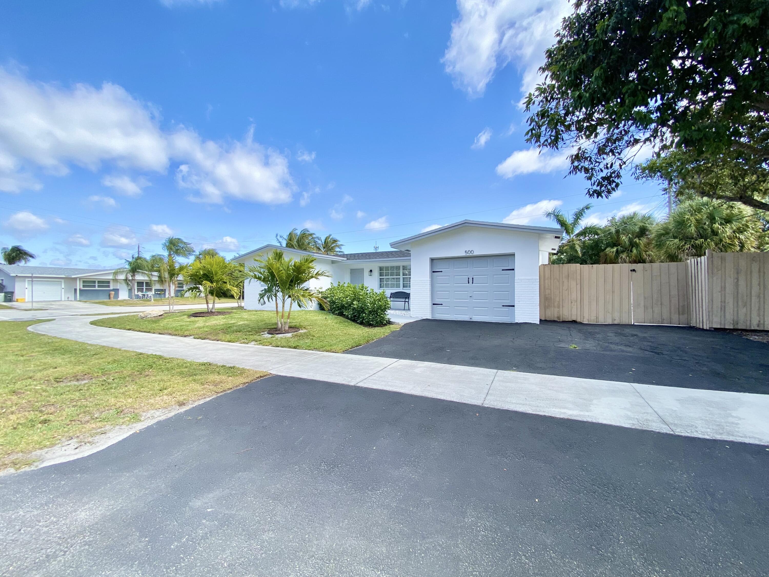 500 Southwest 3rd Avenue Boca Raton, FL 33432 - Photo 37 of 39 a view of an house with a yard and garage