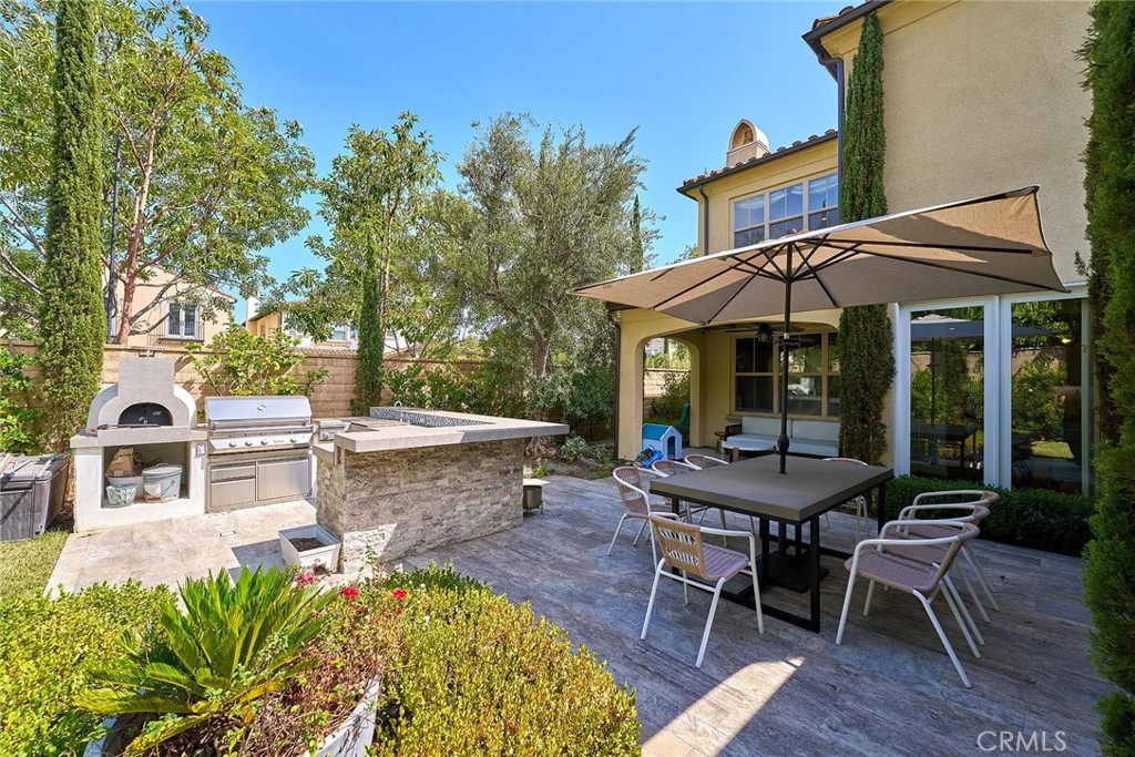 57 Statuary Irvine, CA 92620 - Photo 30 of 66 a view of a house with a chairs and table in a patio
