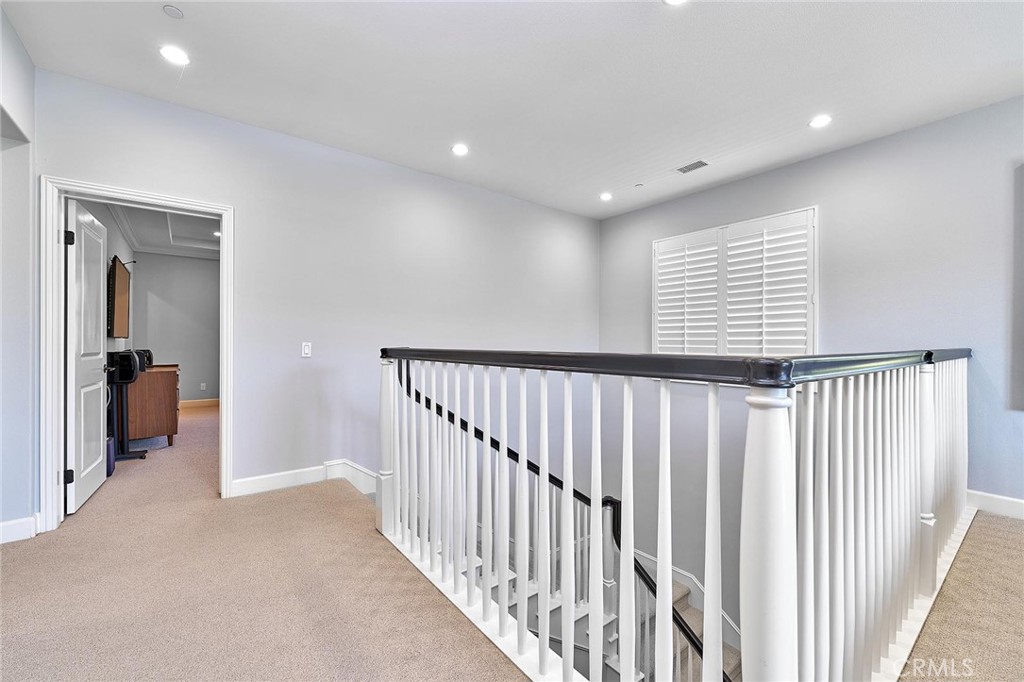 57 Statuary Irvine, CA 92620 - Photo 36 of 66 a view of a hallway with wooden floor and windows
