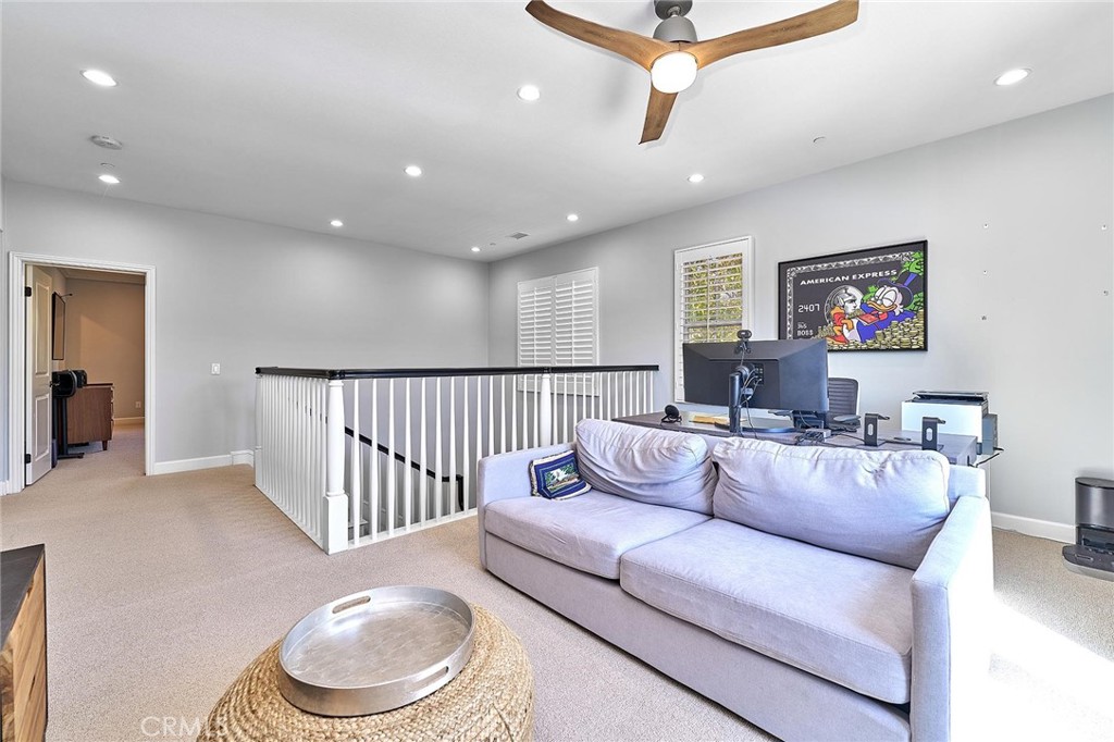 57 Statuary Irvine, CA 92620 - Photo 38 of 66 a living room with furniture and a ceiling fan