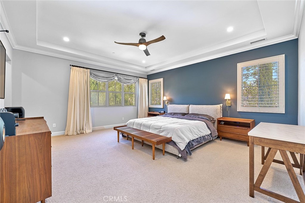 57 Statuary Irvine, CA 92620 - Photo 40 of 66 a spacious bedroom with a bed and a chandelier
