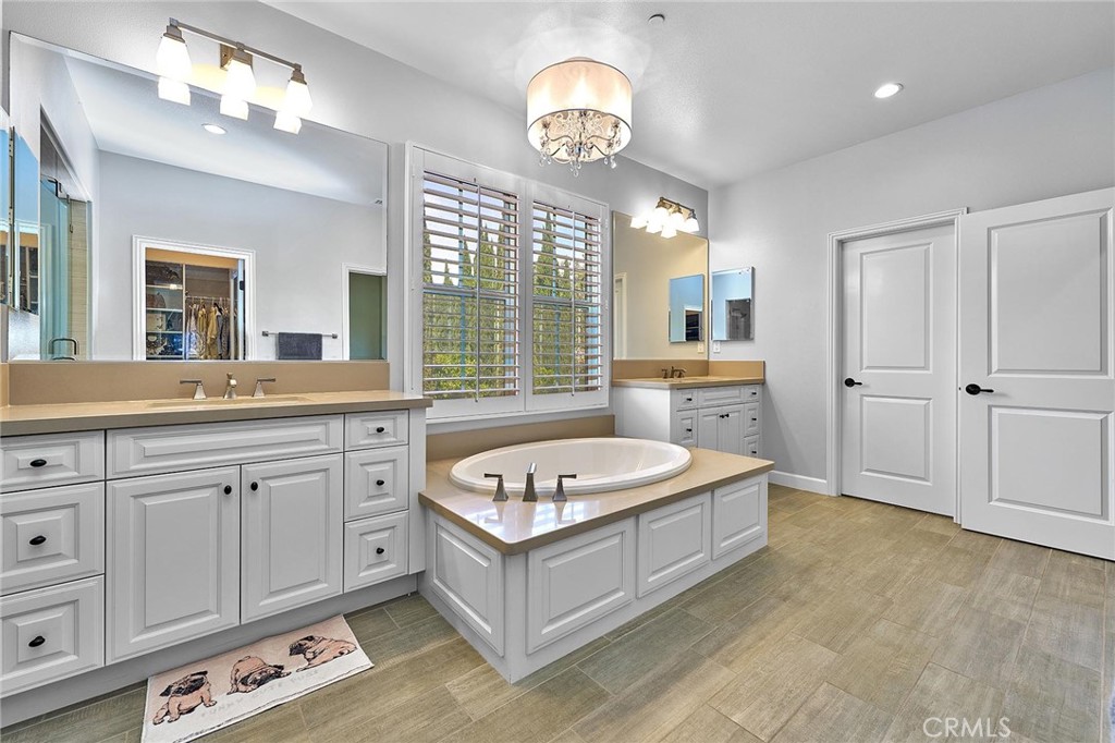 57 Statuary Irvine, CA 92620 - Photo 46 of 66 a spacious en suite bathroom with a double vanity sink a large mirror and a bathtub
