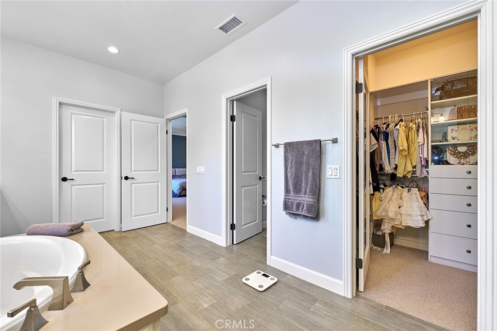 57 Statuary Irvine, CA 92620 - Photo 48 of 66 a spacious bedroom with a bed and walk in closet