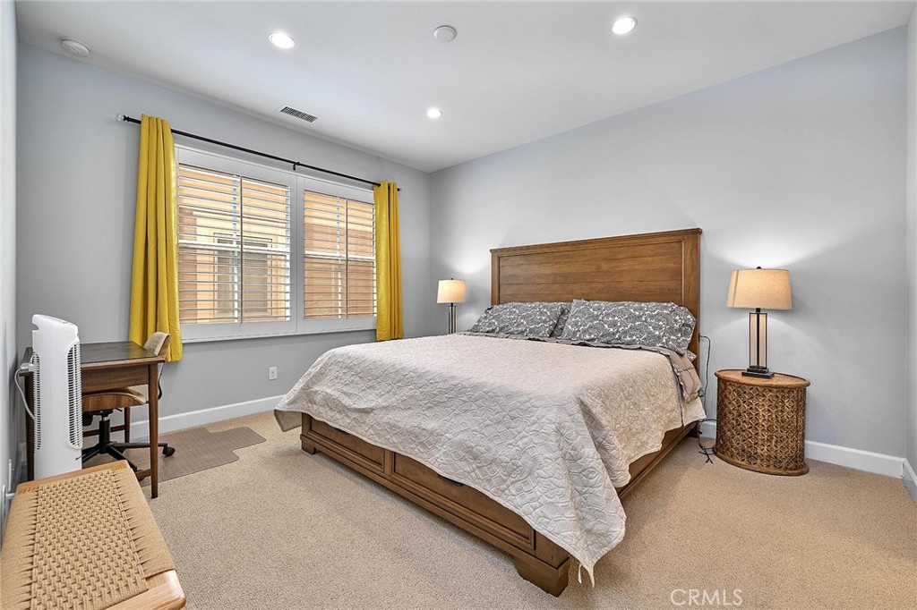 57 Statuary Irvine, CA 92620 - Photo 50 of 66 a bedroom with a bed and a lamp