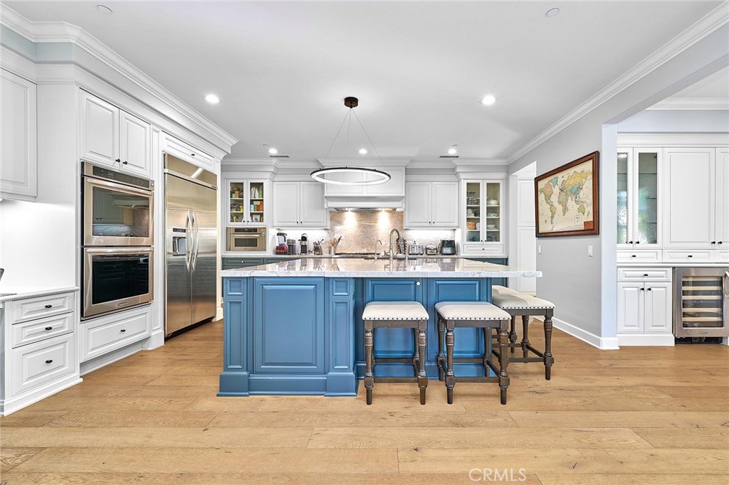 57 Statuary Irvine, CA 92620 - Photo 10 of 66 a kitchen with stainless steel appliances kitchen island granite countertop a table and chairs in it