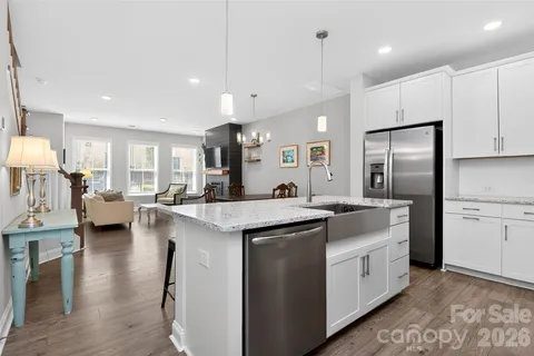 a kitchen with counter top space a sink appliances and cabinets