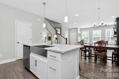 a kitchen with center island table and chairs