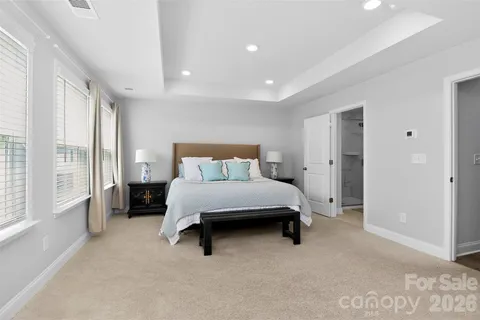 a bedroom with a bed and a large window