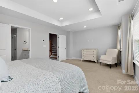 a spacious bedroom with a bed and a couch