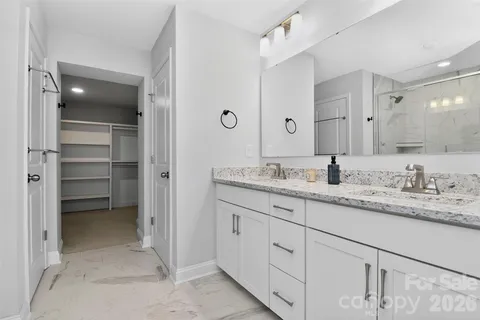 a bathroom with a granite countertop sink double and mirror