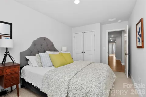 a bedroom with a bed and painting on the wall