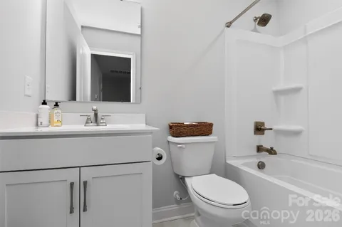a bathroom with a sink mirror vanity and toilet