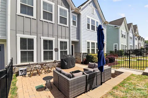 a view of a patio with couches table and chairs with potted plants