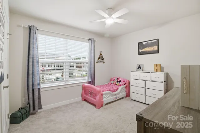 a spacious bedroom with a bed and a window