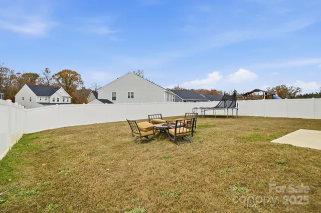 a swimming pool with yard and view of a house