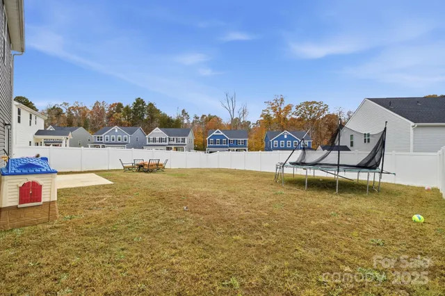 an aerial view of a house with garden space and street view