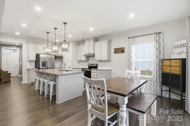 a kitchen with a table and chairs in it