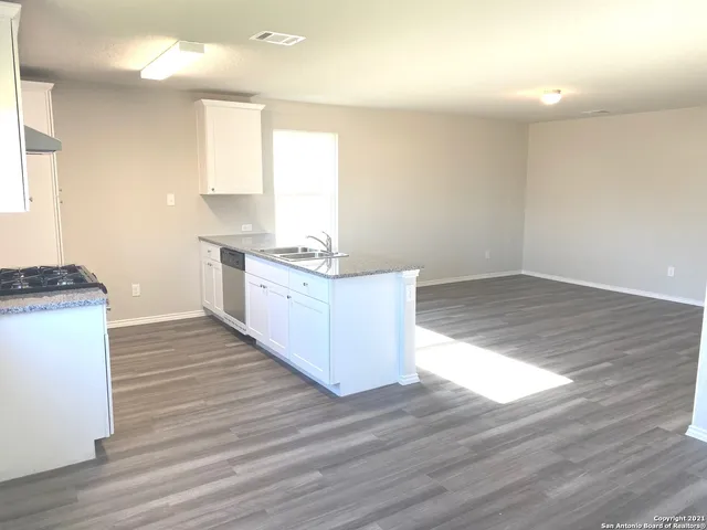 a kitchen with granite countertop a stove and a sink