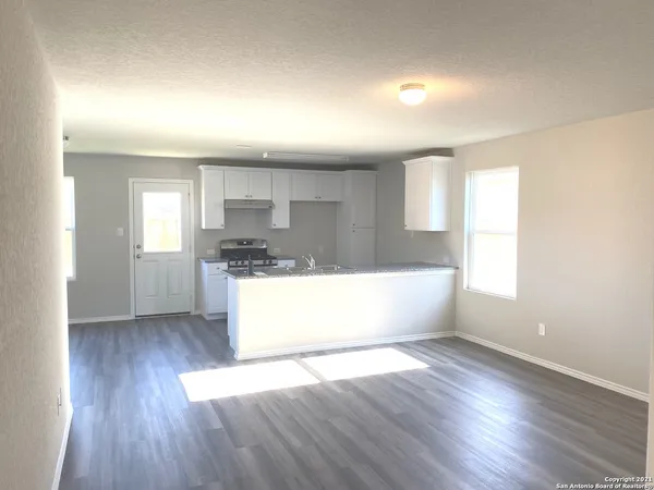 a view of kitchen and wooden floor