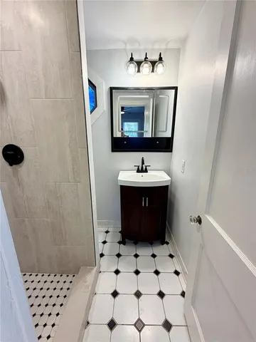 a bathroom with a sink a toilet and a mirror