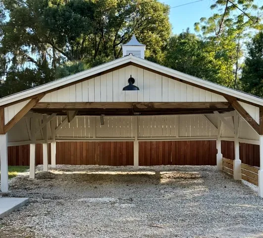 a view of a small barn with a small yard