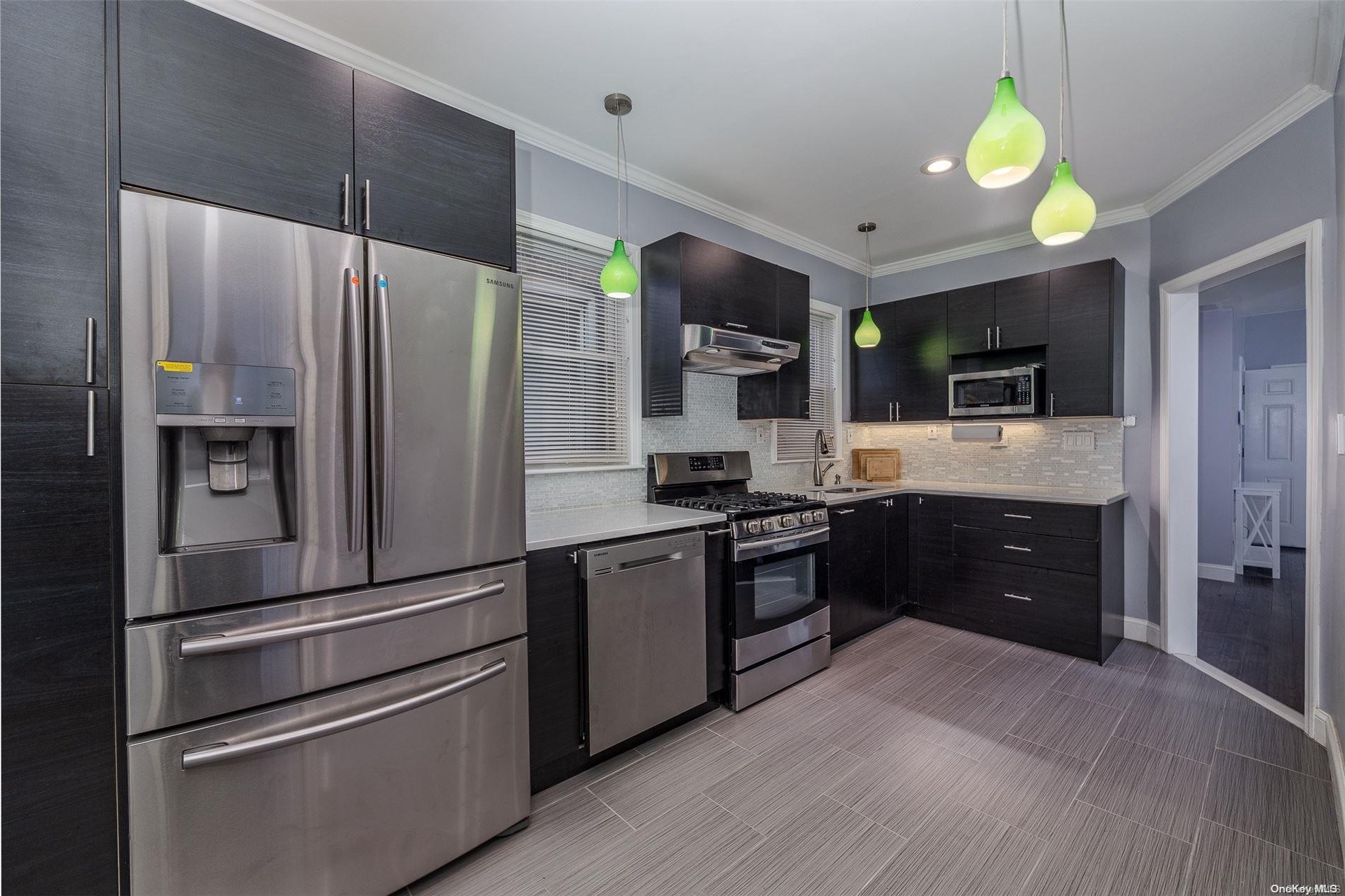33-46 96th Street Queens, NY 11368 - Photo 1 of 1 a kitchen with stainless steel appliances granite countertop a refrigerator and a stove