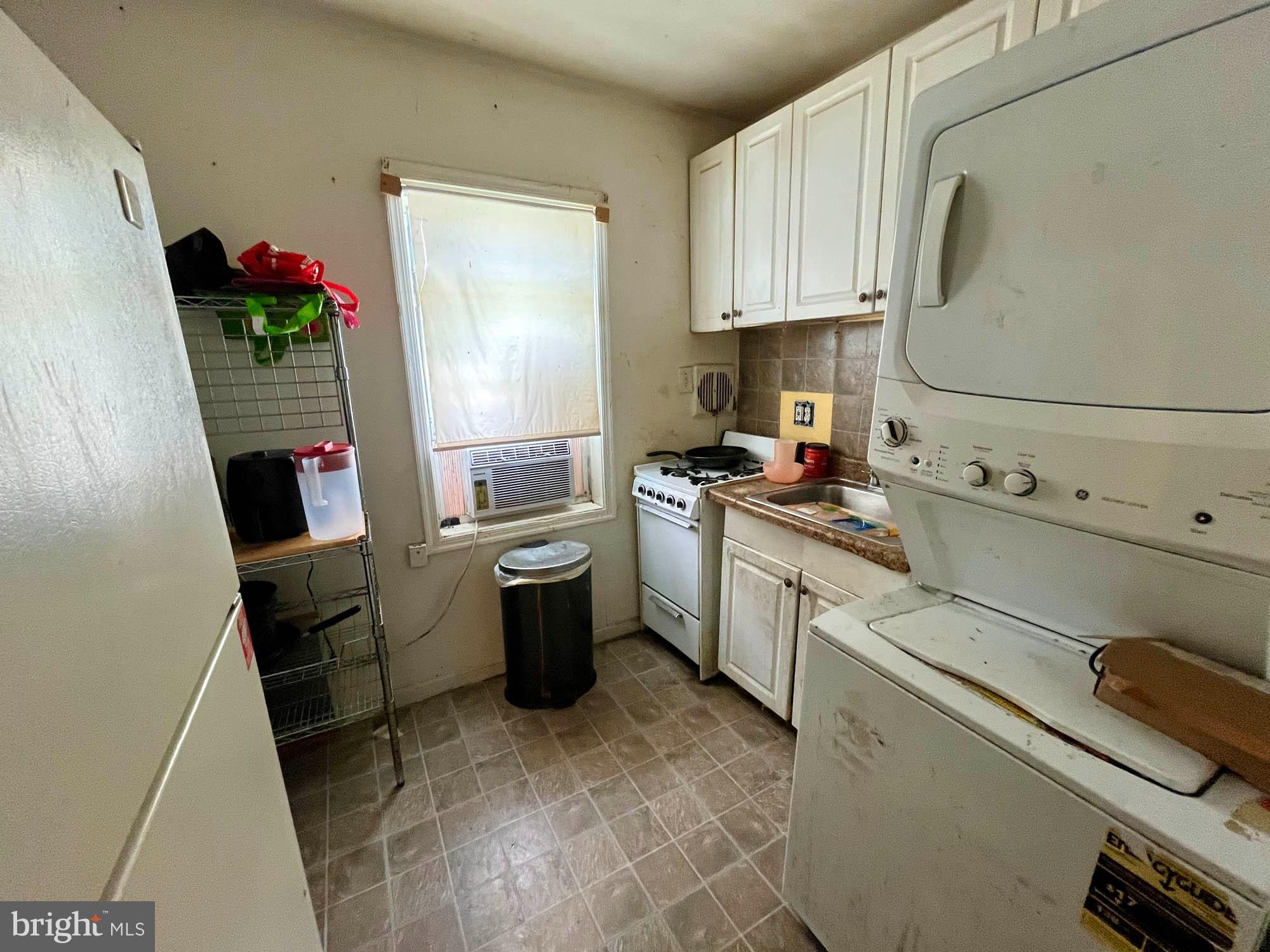 1727 Earhart Road Baltimore, MD 21221 - Photo 22 of 48 a kitchen with sink cabinets and appliances