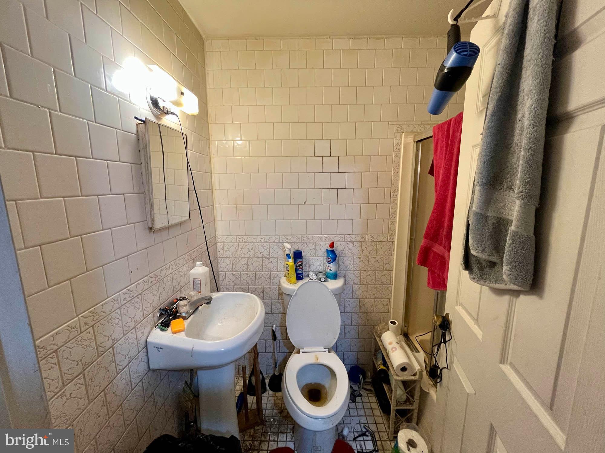 1727 Earhart Road Baltimore, MD 21221 - Photo 32 of 48 a bathroom with a sink and a mirror