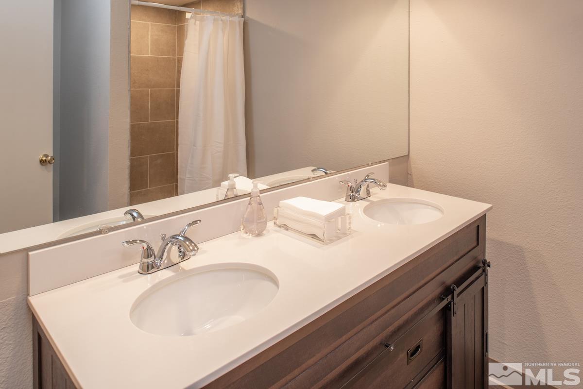 5038 Lakeridge Terrace East Reno, NV 89509 - Photo 14 of 23 a bathroom with a sink and a mirror