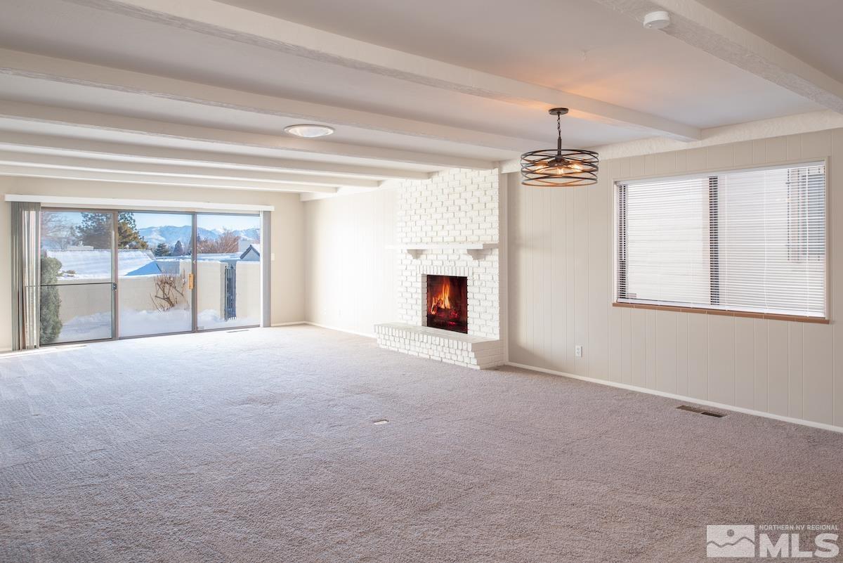 5038 Lakeridge Terrace East Reno, NV 89509 - Photo 3 of 23 a view of a livingroom with a fireplace and window
