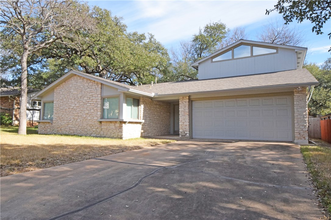 a front view of a house with a outdoor space and yard