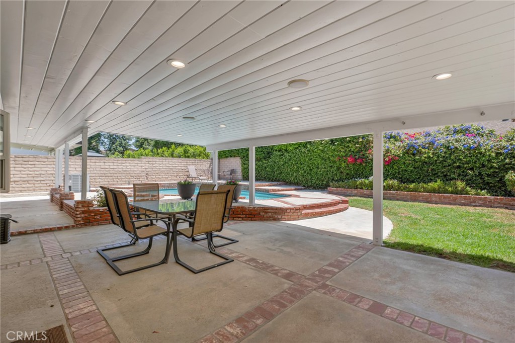 2146 North Brower Street Simi Valley, CA 93065 - Photo 35 of 51 a view of a patio with table and chairs with wooden fence and plants