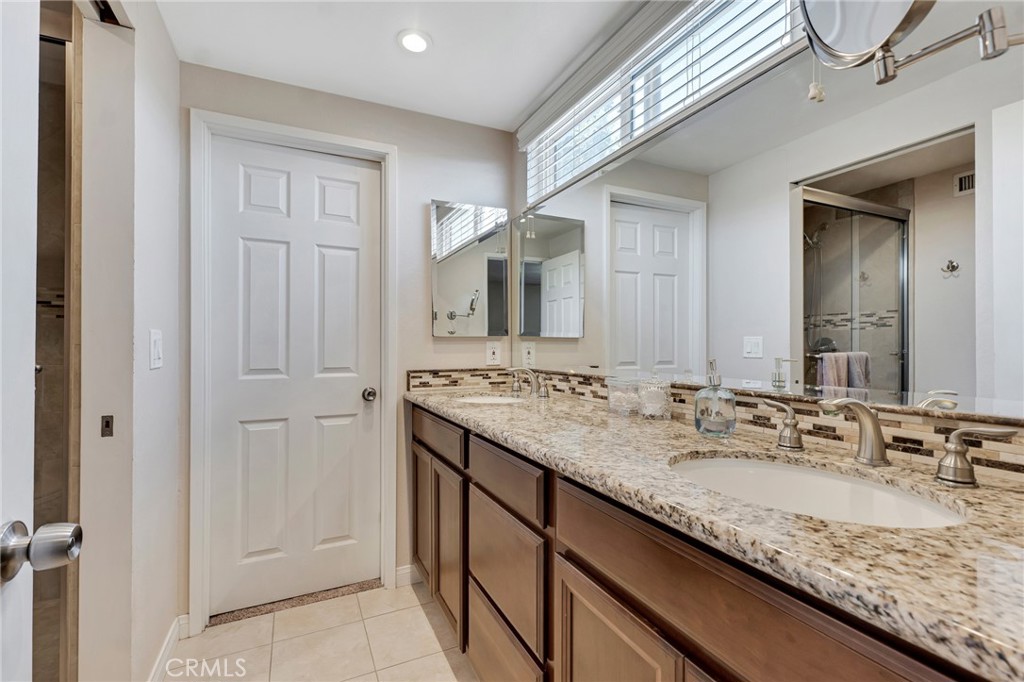 2146 North Brower Street Simi Valley, CA 93065 - Photo 41 of 51 a bathroom with a granite countertop sink and a mirror