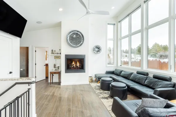 a kitchen with stainless steel appliances granite countertop a refrigerator a stove and a sink with wooden cabinets