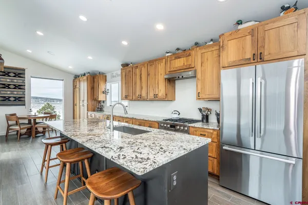 a large kitchen with granite countertop a large window and a counter space